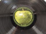 vinyl record with a green apple on it sitting on top of a table