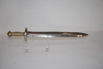 a close up of a knife on a stand on a white surface