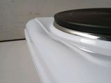 a close up of a white toilet with a black lid