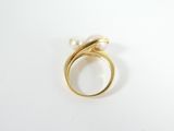 a close up of a gold ring with a pearl in it
