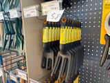 a rack of gardening tools in a store for sale