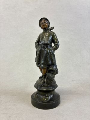 bronze figurine of a boy with a bird on his shoulder