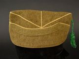a brown bag with a green tassel on it
