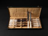 a case that has a set of pens and a knife in it