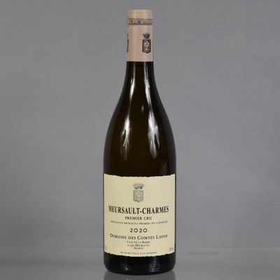 a bottle of wine sitting on top of a table next to a bottle of wine