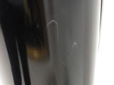 a close up of a black vase on a white table