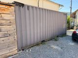 a car that is parked in front of a fence