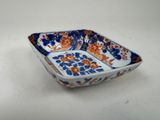 a small blue and orange bowl on a white table