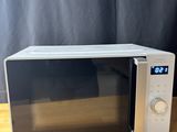 a microwave that is sitting on a wooden table