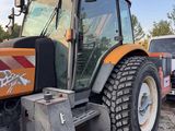 a tractor that is parked on the side of the road