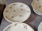many plates and bowls sitting on a table