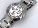an image of a close up of a wrist watch on a white surface