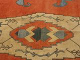 a red and blue rug with a design on it