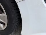 a close up of a car ' s tire on the street