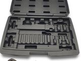 a tool kit in a plastic case on a white surface