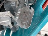 a pile of metal parts in a blue container