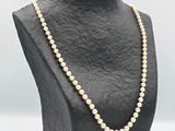 a close up of a mannequin with pearls on it