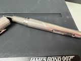 a silver pen sitting on top of a black box