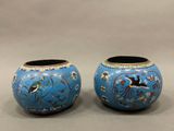 pair of blue vases with birds and flowers painted on them