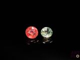two different colored gems sitting on top of each other in the dark