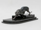 statue of a dog on a stand on a white background