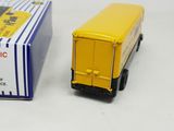 a toy truck that is next to a box on the table