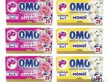 quatre boîtes de lessive Omo sur fond blanc