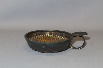 a small metal bowl with a spoon in it