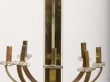 a chandelier made of brass and glass on a pedestal
