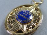 a gold medal with a blue medallion on it