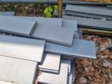 many pieces of concrete sitting on the ground next to each other