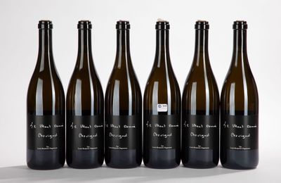 six bottles of wine are lined up in a row