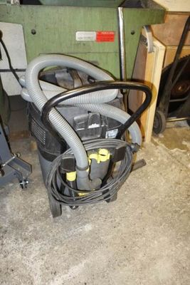 an image of a vacuum and other equipment in a garage