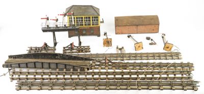 a lot of toy train tracks and a small building