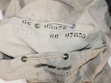 a bag that is sitting on the ground with a tag on it