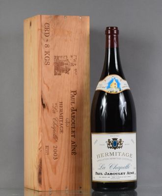 a bottle of wine sitting next to a wooden box