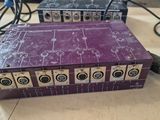 a close up of a purple electronic device on a table