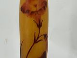 a glass vase with a flower on it on a table