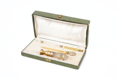 a green case with a pen and a pair of scissors in it