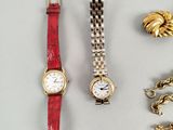 several different types of watches and bracelets on a white surface