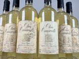six bottles of white wine are lined up in a row