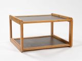 a small wooden table with a glass top on a white background