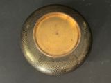 a gold vase sitting on a table with a black background
