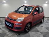 the small red car is parked on a checkered floor