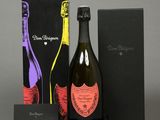 two bottles of champagne and a box of chocolates on a table