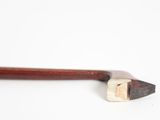 an image of a close up of a wooden stick on a white surface