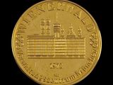 une image montrant un gros plan d'une pièce d'or sur laquelle figure un bateau