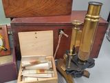 many different types of microscopes sitting on a table