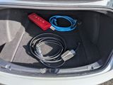 a trunk of a car with a bunch of cables in it