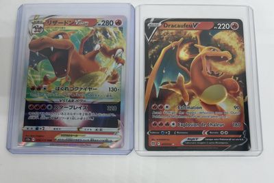 two pokemon cards are sitting side by side on a table